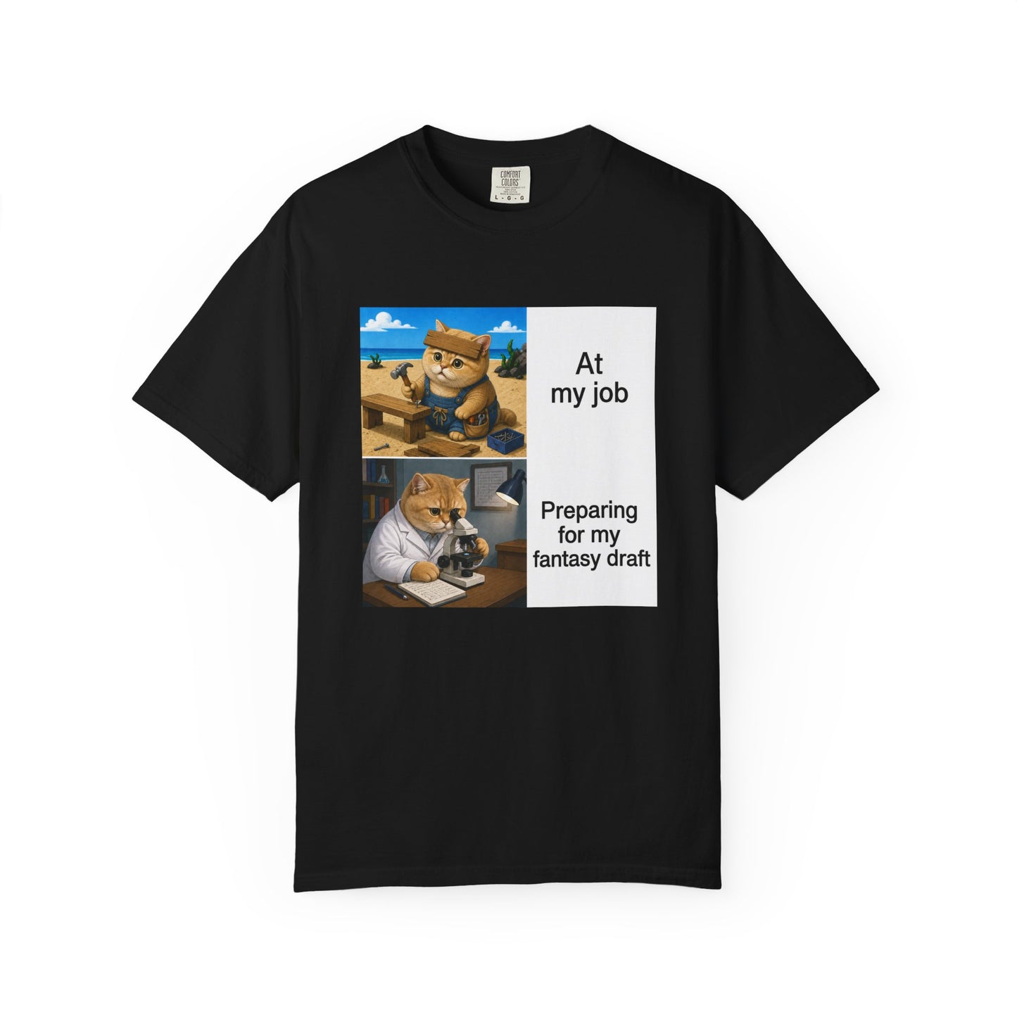Black Comfort Colors 1717 t-shirt with a square two-panel print on an off-white card across the chest: an orange cat in denim overalls hammering a nail into a wooden bench on a beach, captioned At my job, above the same cat in a white lab coat hunched over a microscope beside a notebook of stats, captioned Preparing for my fantasy draft.