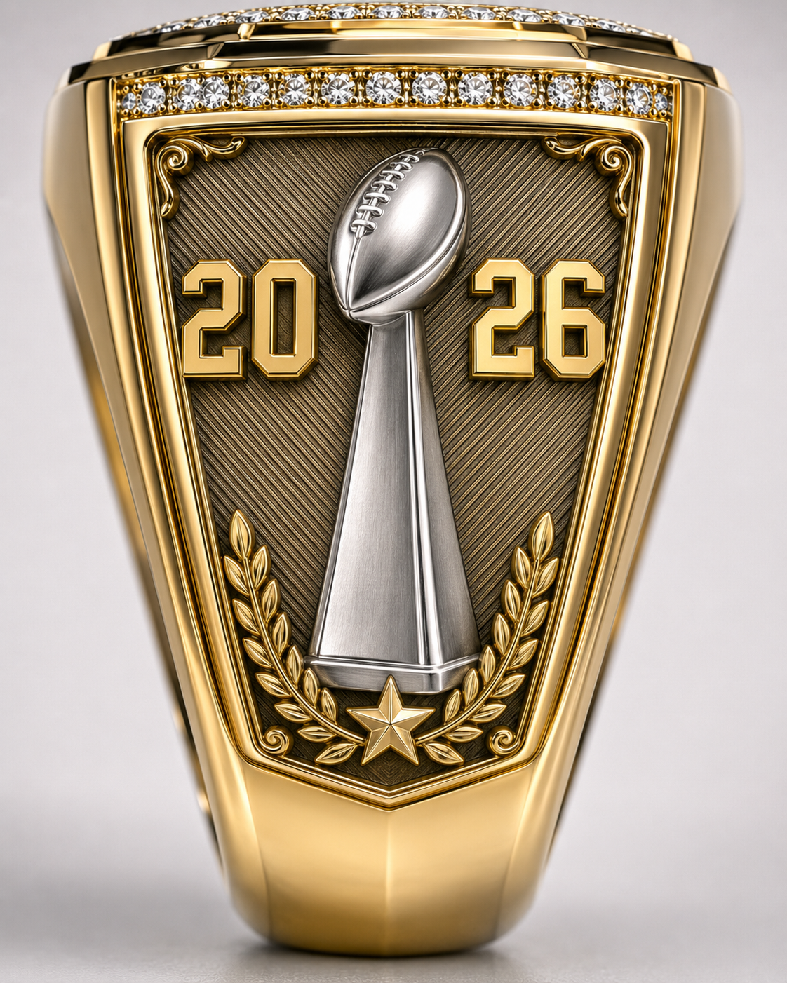 Custom League Champion Ring, shoulder view. A silver championship trophy with 2026 numerals sits over a textured gold shield with laurel and star detail.